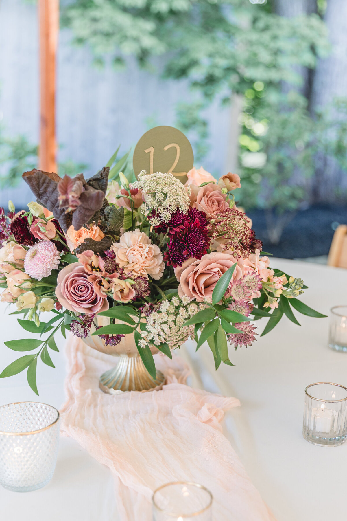 Peach, blush, and dark purple wedding flower