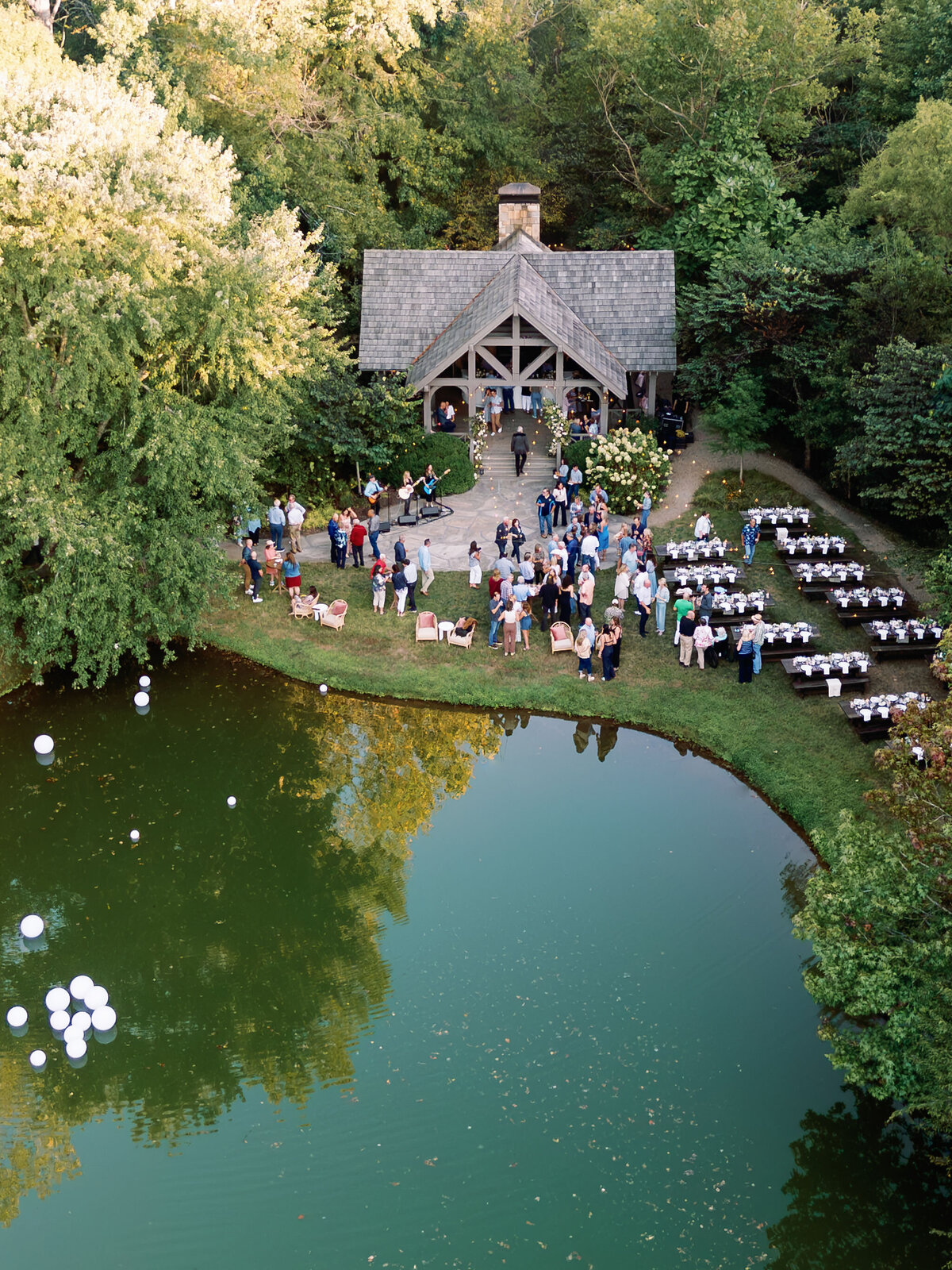 Fall wedding at Blackberry Farm. Welcome party for wedding guests at Yallerhammer Pavilion on property at Blackberry Farm. Growing floral installation with whimsical florals for entrance to reception. Rustic and earthy floral design with elegant notes of blush and cream. Wildflower design in ikebana style with glowing candlelight reception tables. Destination wedding at Blackberry Farm. Design by Rosemary & Finch Floral Design in Nashville, TN.