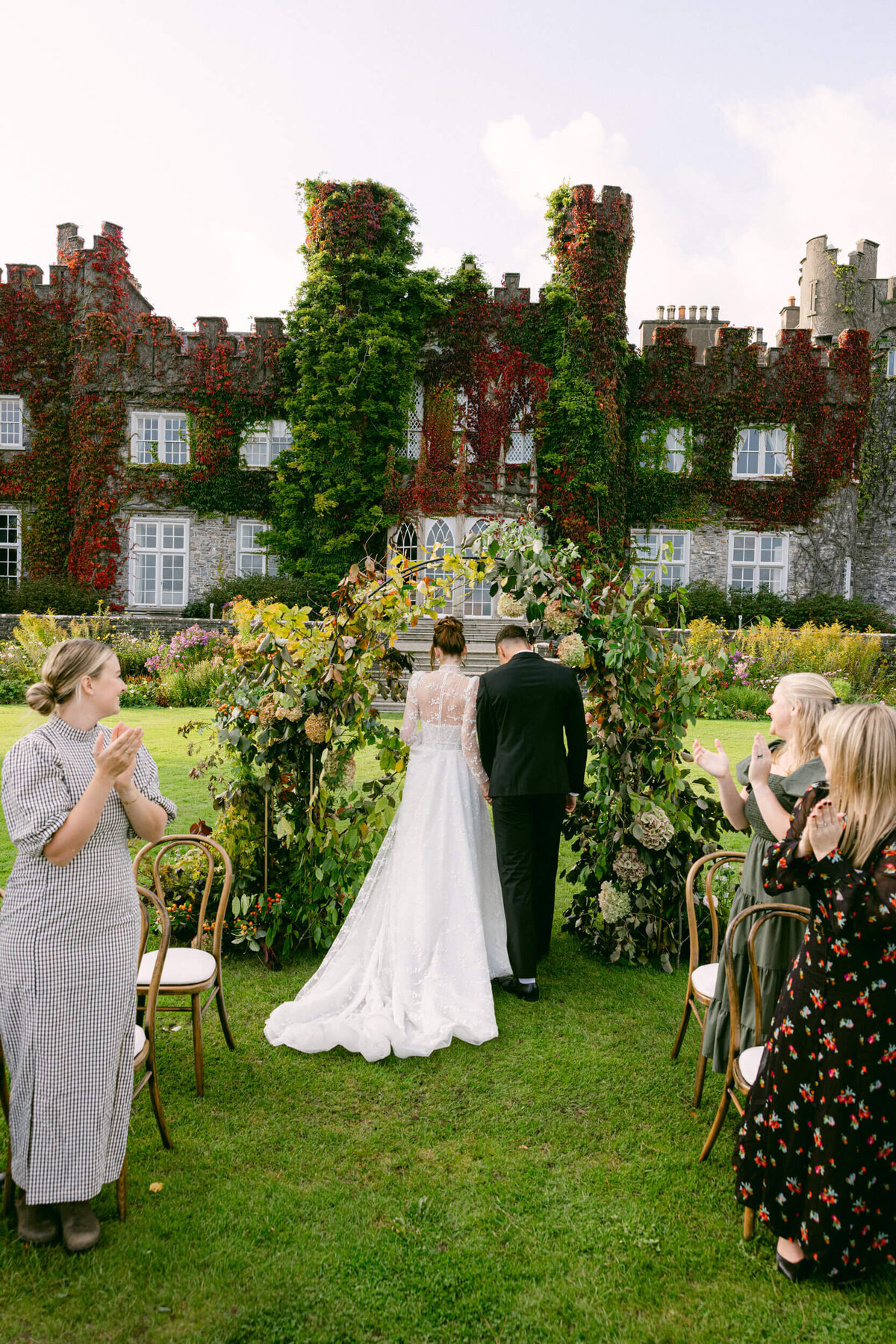 A wedding day photo of the bride and groom at the alter during their wedding ceremony at Luttrellstown Castle in Dublin Ireland