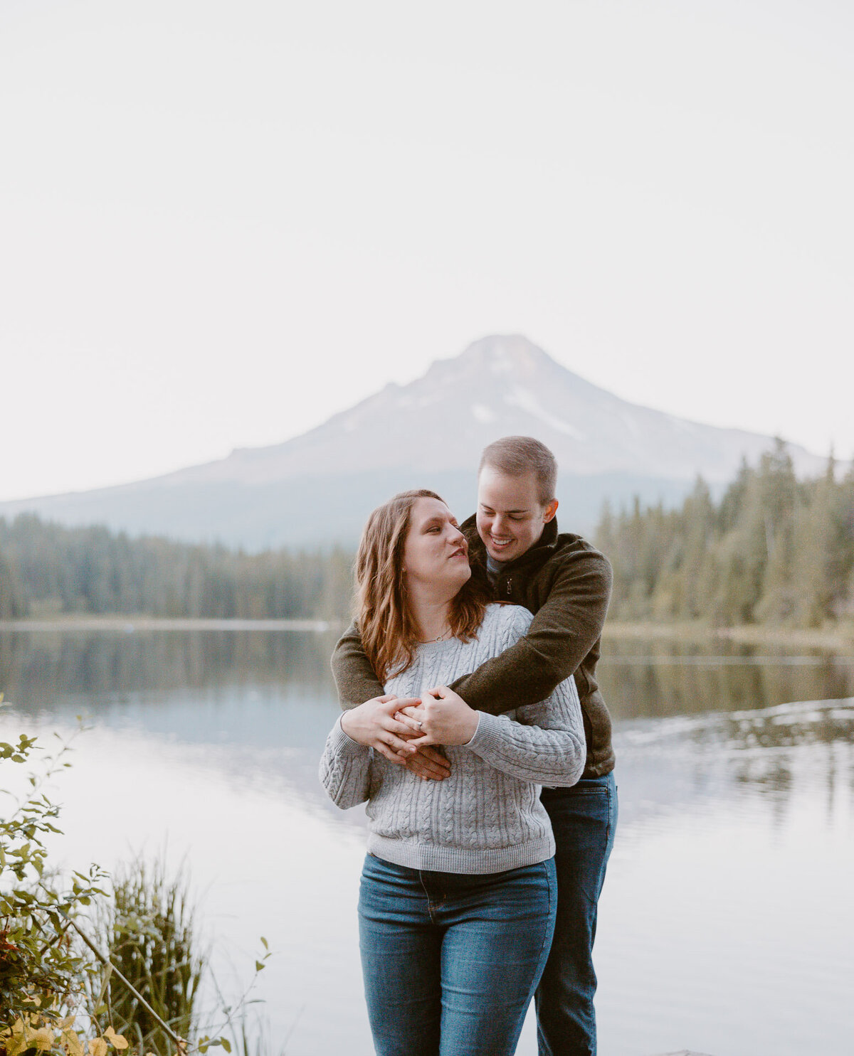 engagement photo taken in front of the lake and mountain at trillium lake oregon