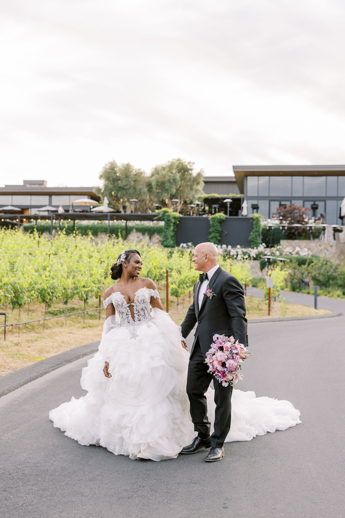 Bride and groom walking through a vineyard in Napa Valley