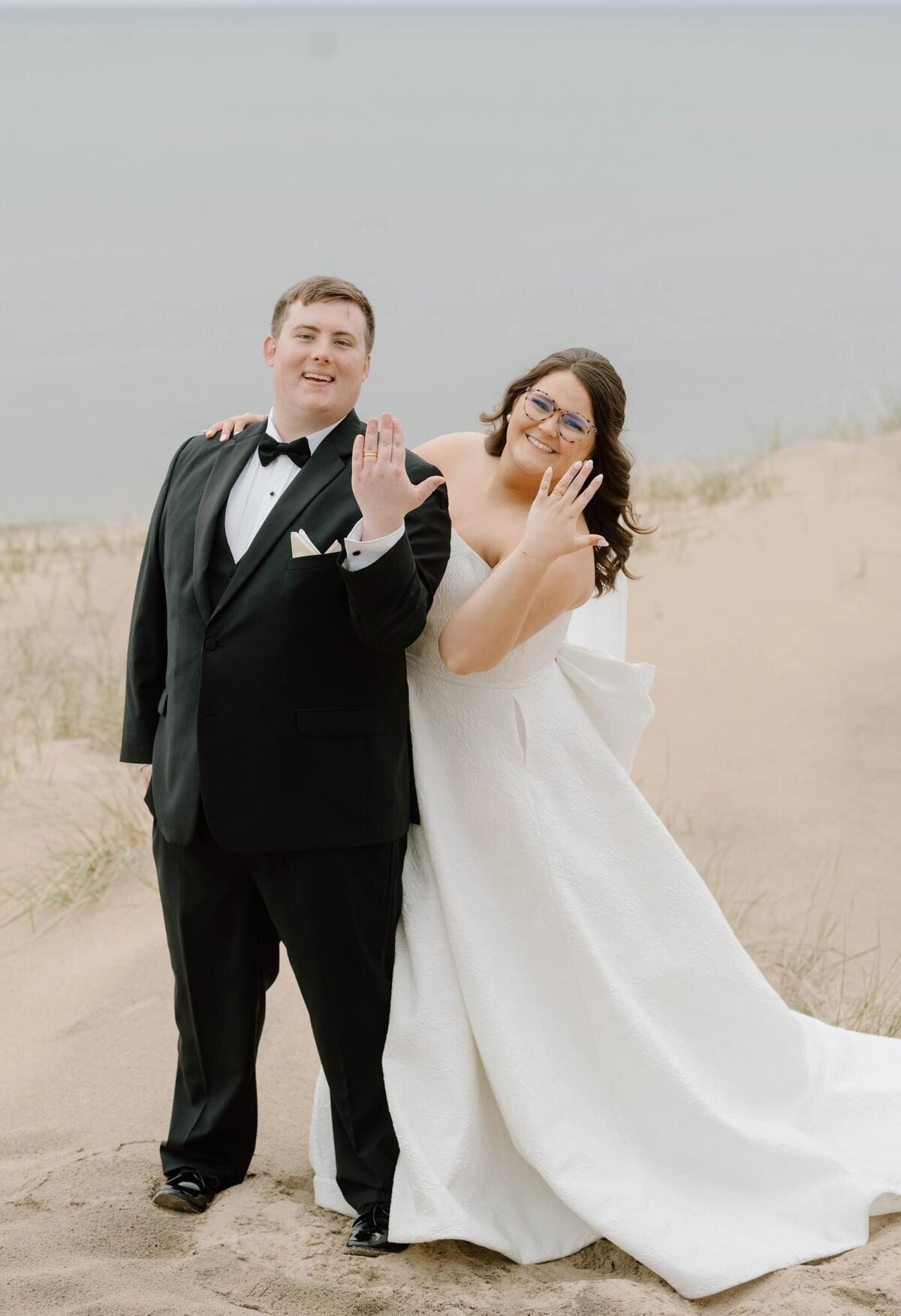 Michigan wedding photographer with a couple on the beach