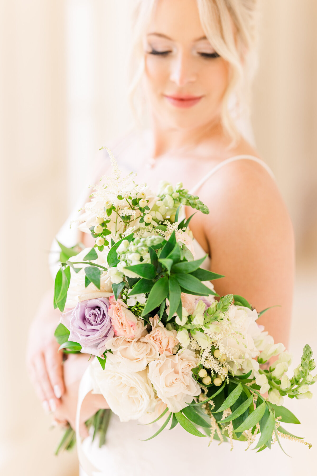 bride-looking-down-at-herr-gorgeous-bouquet