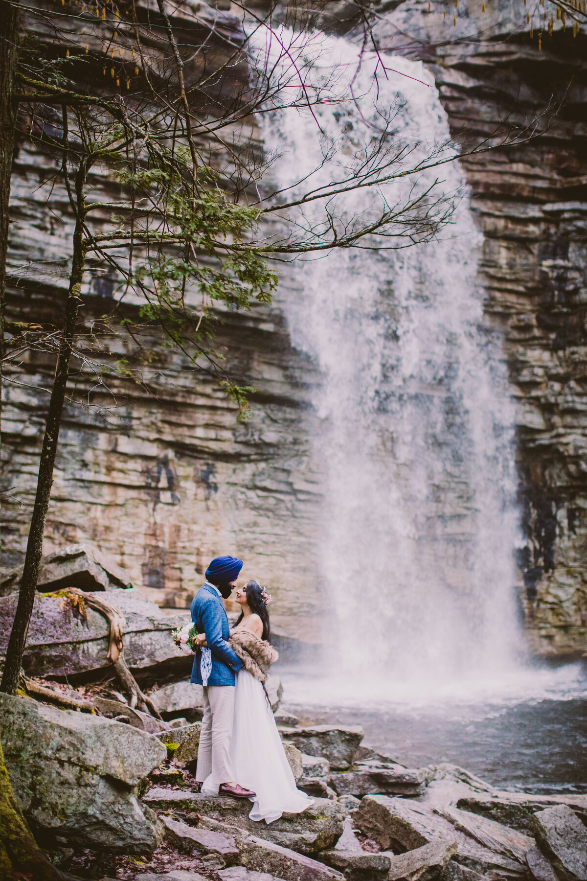 An engagement couple share a moment in front of the awosting waterfalls at minnewaska state park in upstate new york