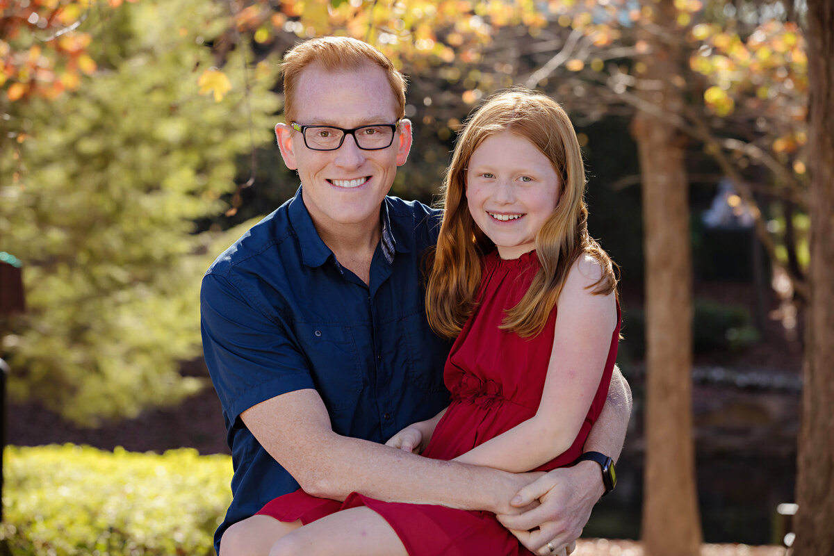Tender father‑daughter photo in a picturesque fall park setting at Ballantyne Corporate Park Charlotte NC