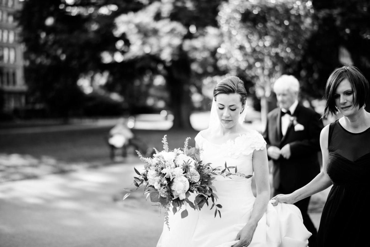 Bride walking through the Boston Public Gardens in black and white.