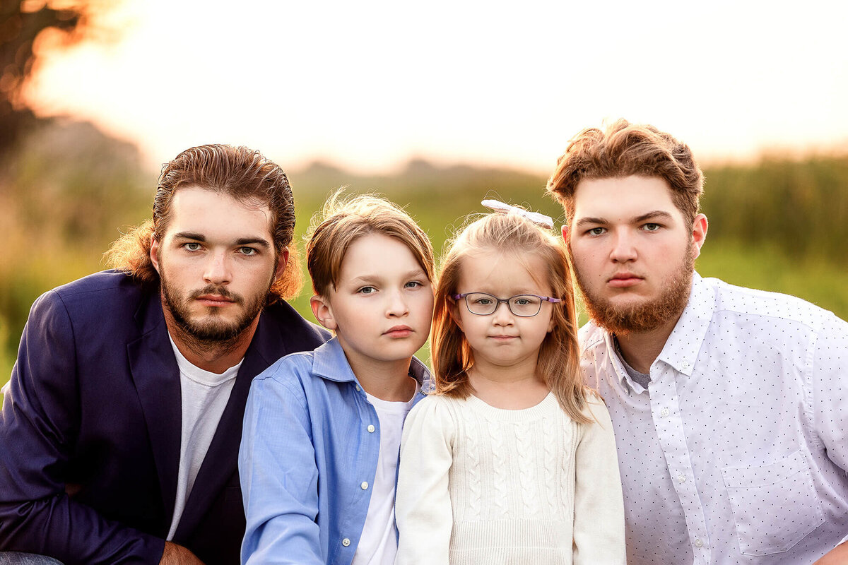 Up close image of four children posed during their family portrait session.