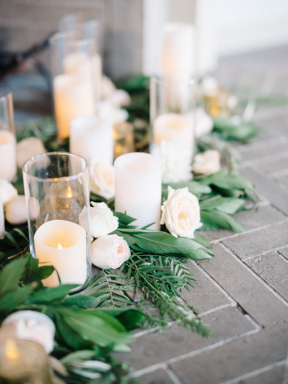 candles, greenery and loose blooms