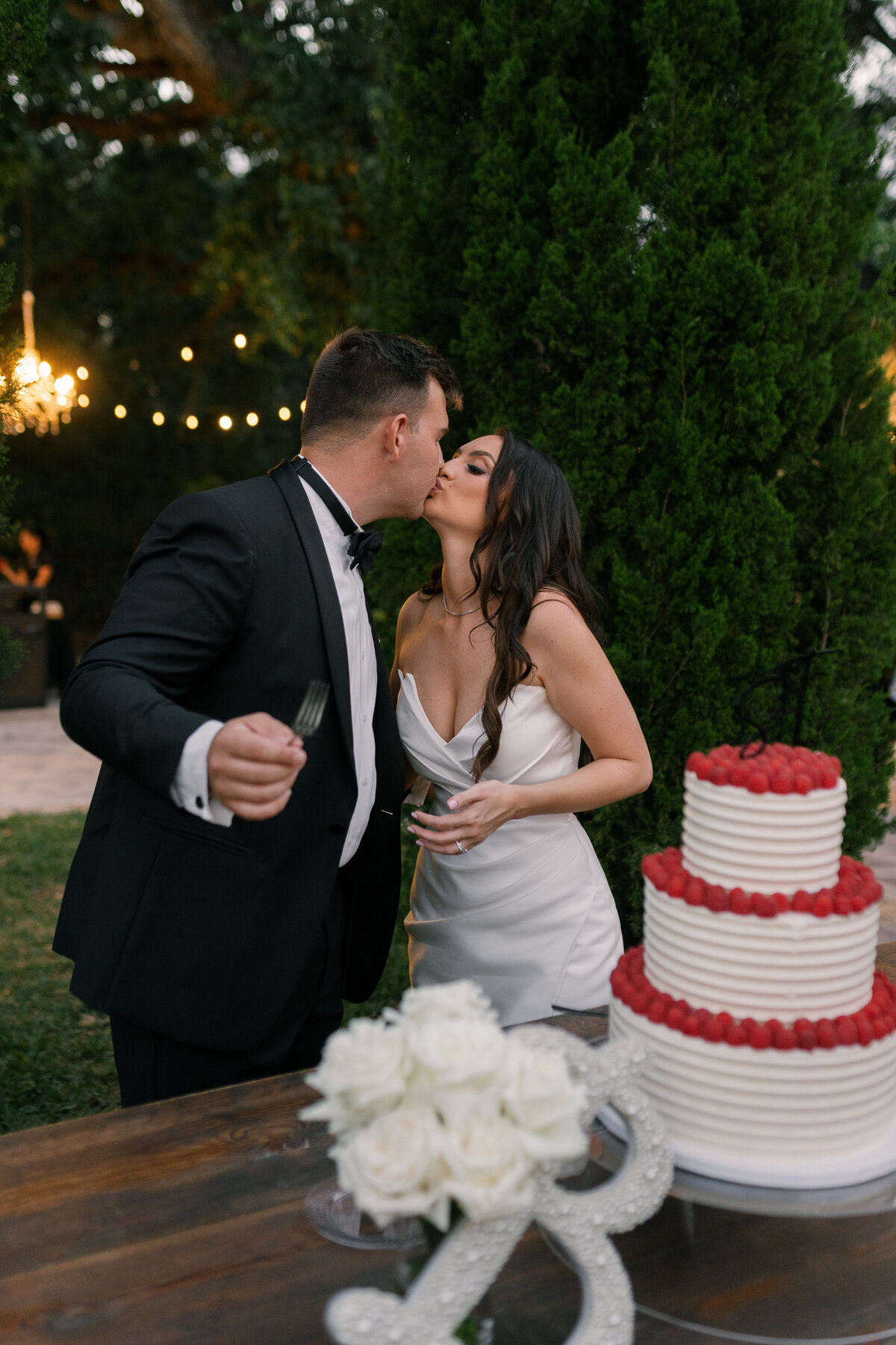 Couple kissing during cake cutting at La Casa Toscana Wedding Venue Fort Myers Florida