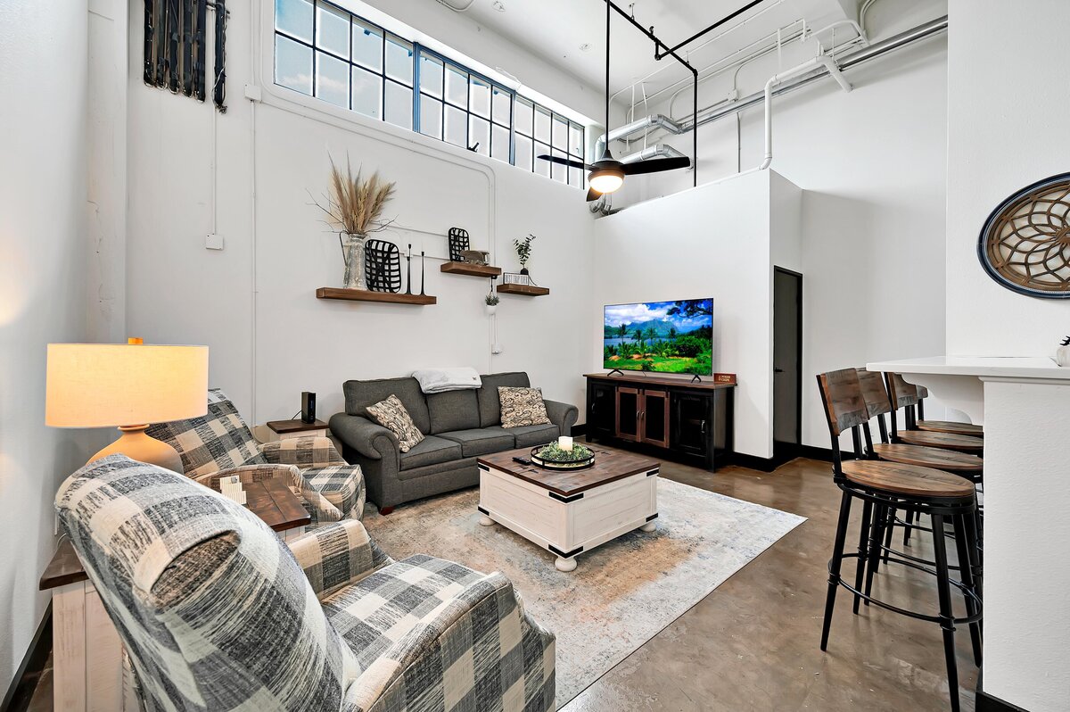 Living area seating in this industrial two-bedroom, two-bathroom first floor rental condo in the historic Behrens Building in downtown Waco, TX.