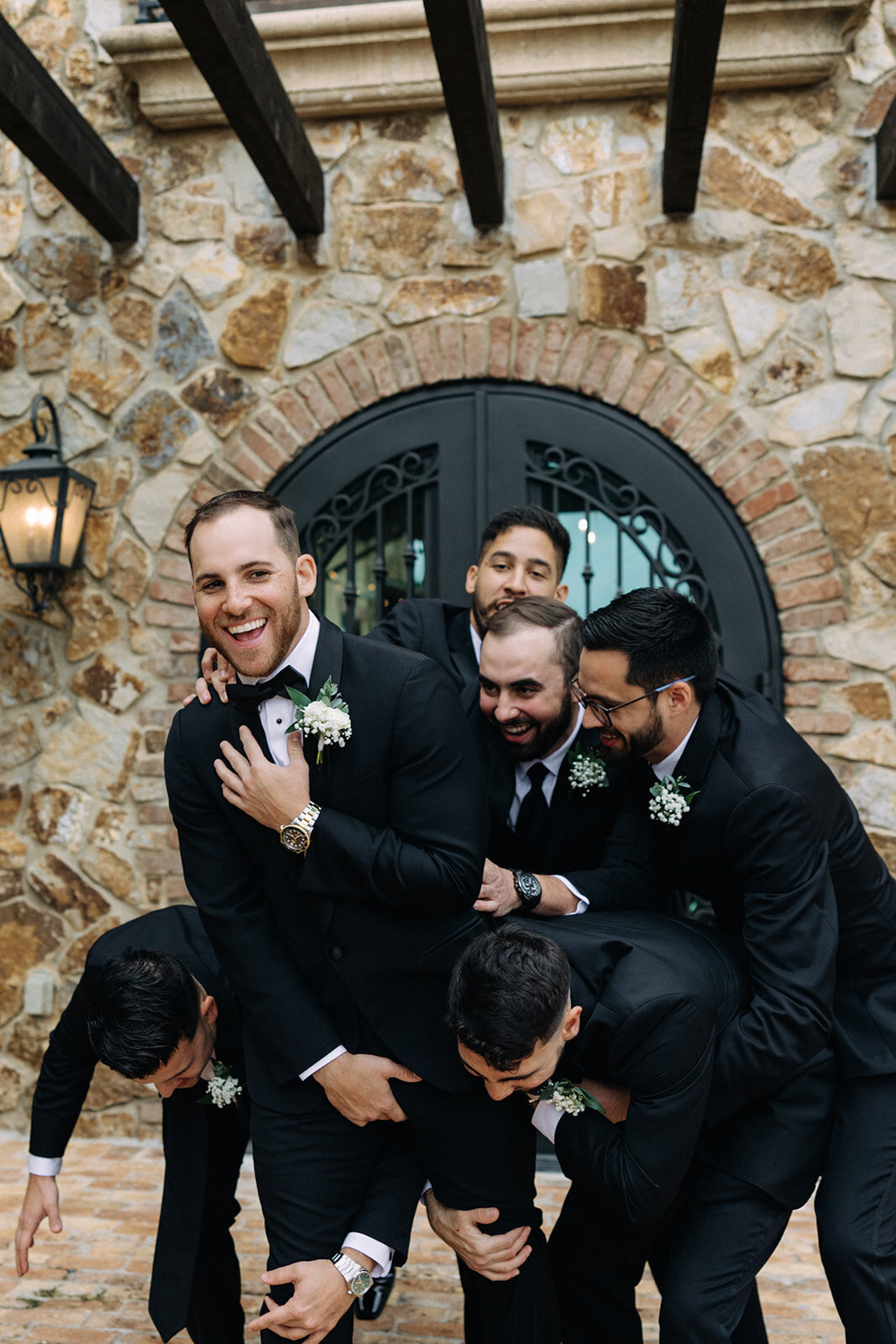 groomsmen hugging and laughing at bella collina orlando wedding​