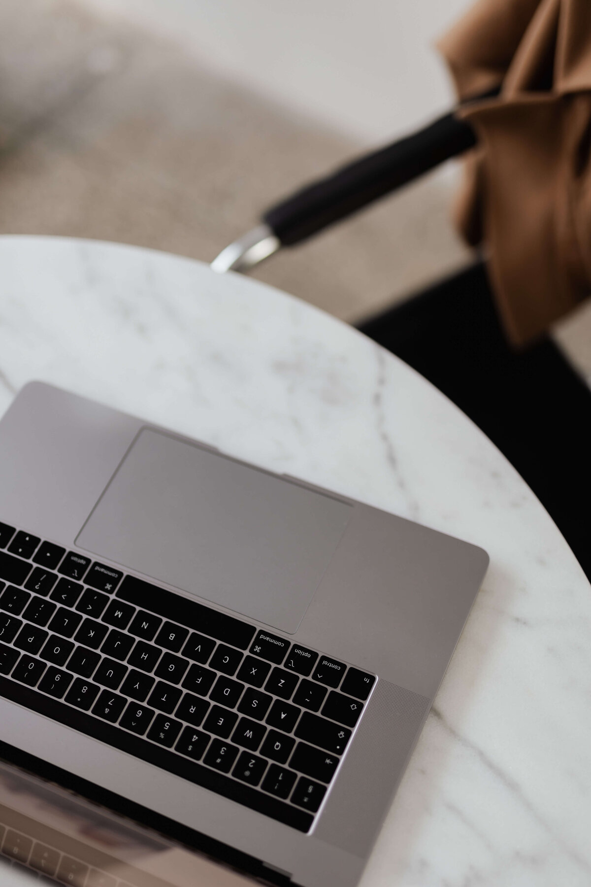 Two female business owners working on laptop and making notes