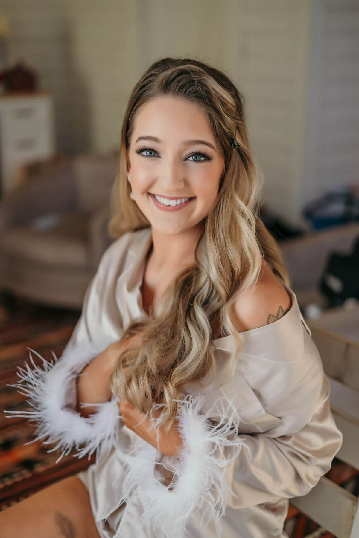 Bride getting ready with soft waves and Balayage highlights, captured after wedding day hair and makeup session in San Antonio