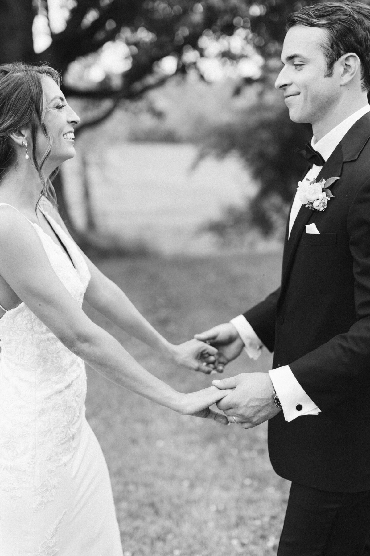 bride-and-groom-holding-hands-and-smiling