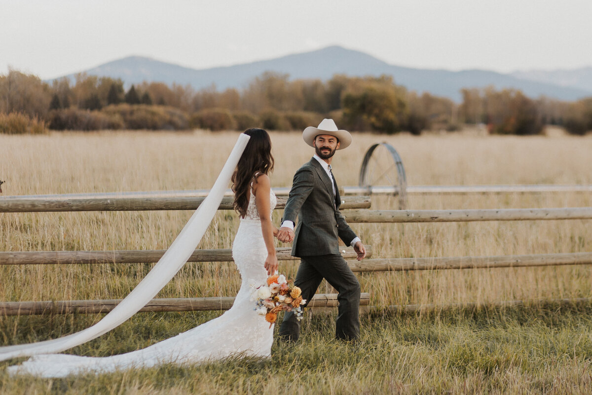 bride and groom walking on a ranch in Montana