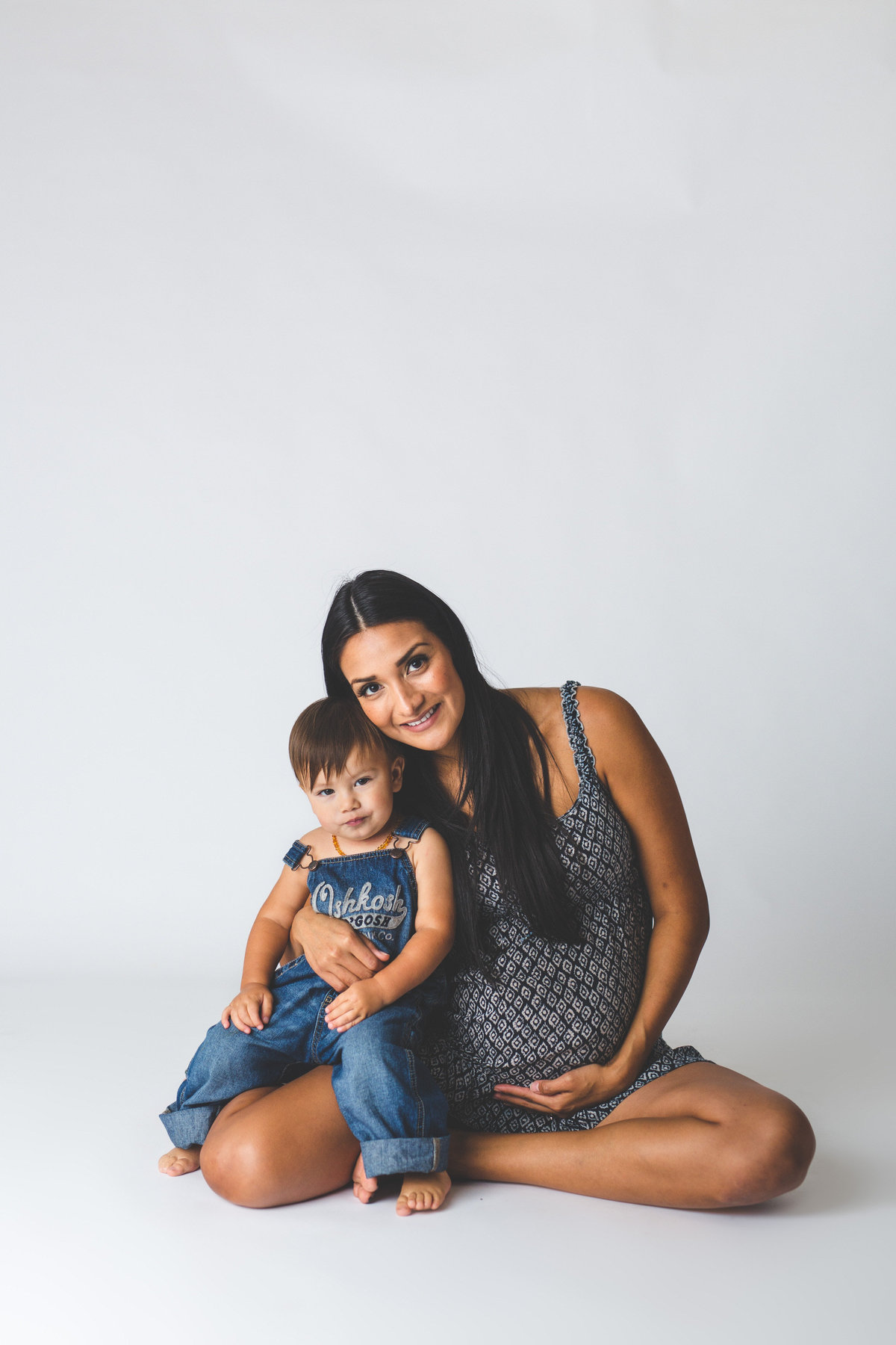 San Antonio In studio family maternity session on a white background with mother holding toddler son.