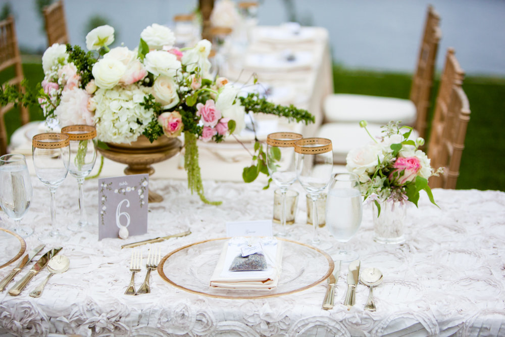 Romantic outdoor wedding reception  on the lawn with gold and blush accents.