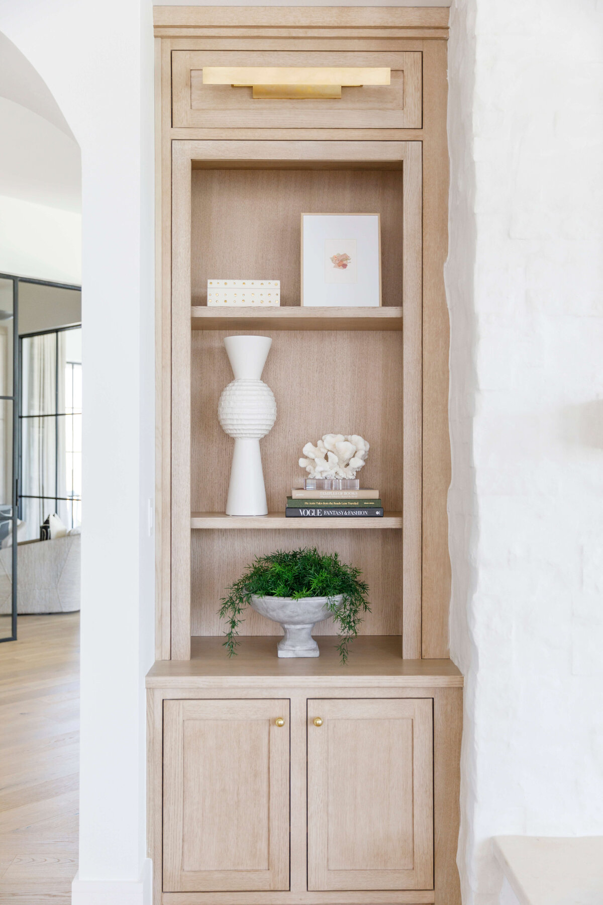 oyster creek studios hughes light wooden shelving with plants and white vase