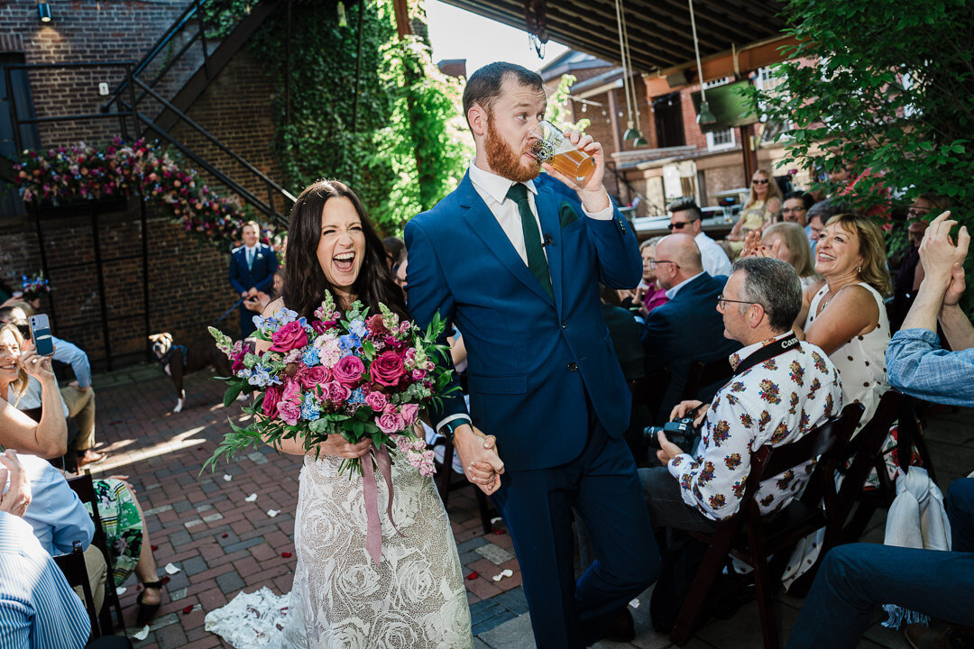 Bride and groom celebrating recessional with big smiles and vibrant bouquet at New Jersey wedding