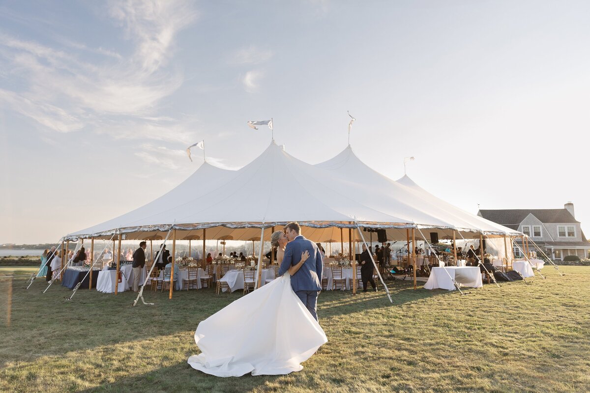 Couple kiss in front of a sperry tent during Salters Point wedding. Deborah Zoe Photography.