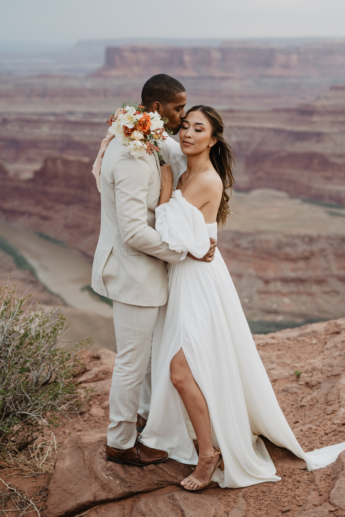 Utah Elopement Photographer captures groom kissing bride's cheek