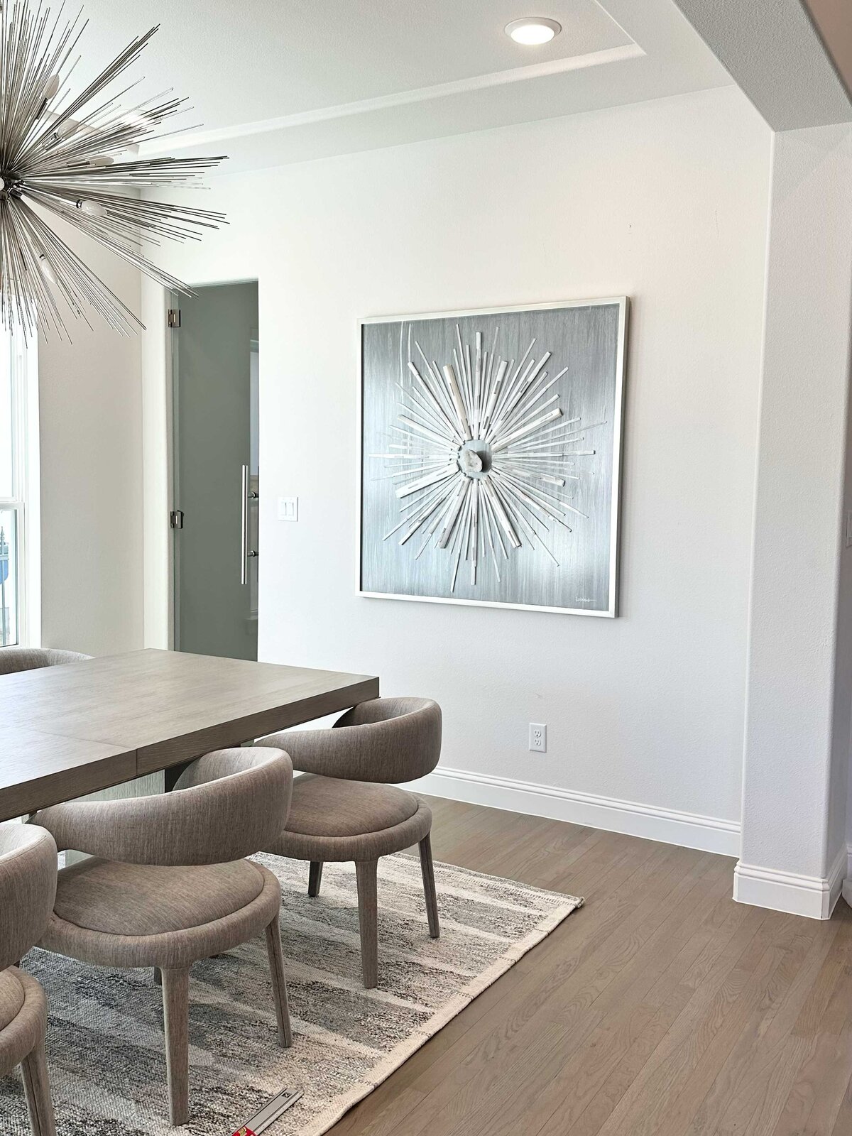 Interior design contractor near me showcasing an interior design project, with a stylish space decorated in grey and white tones, complemented by a vibrant pop color artwork for added flair.