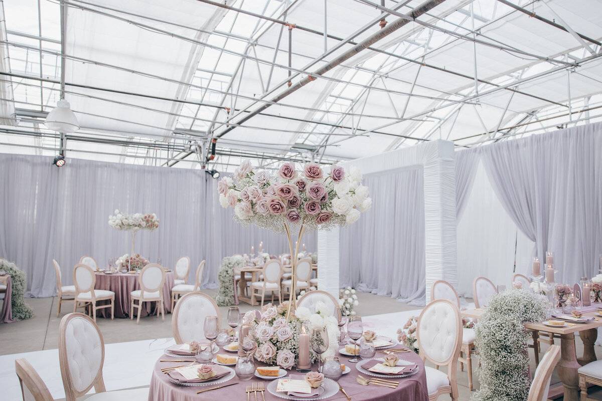 Glamorous indoor wedding with rose centre pieces and lavender tablecloths