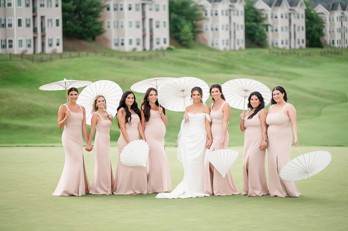 bride and bridesmaids with parasols