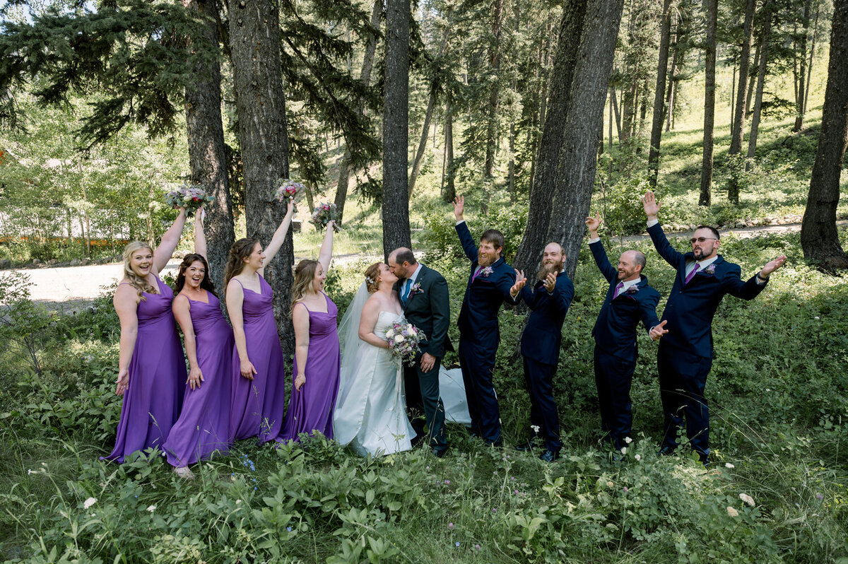 Wedding party cheering for the bride and groom during a summer wedding at The Woodlands at Cottonwood Canyon.