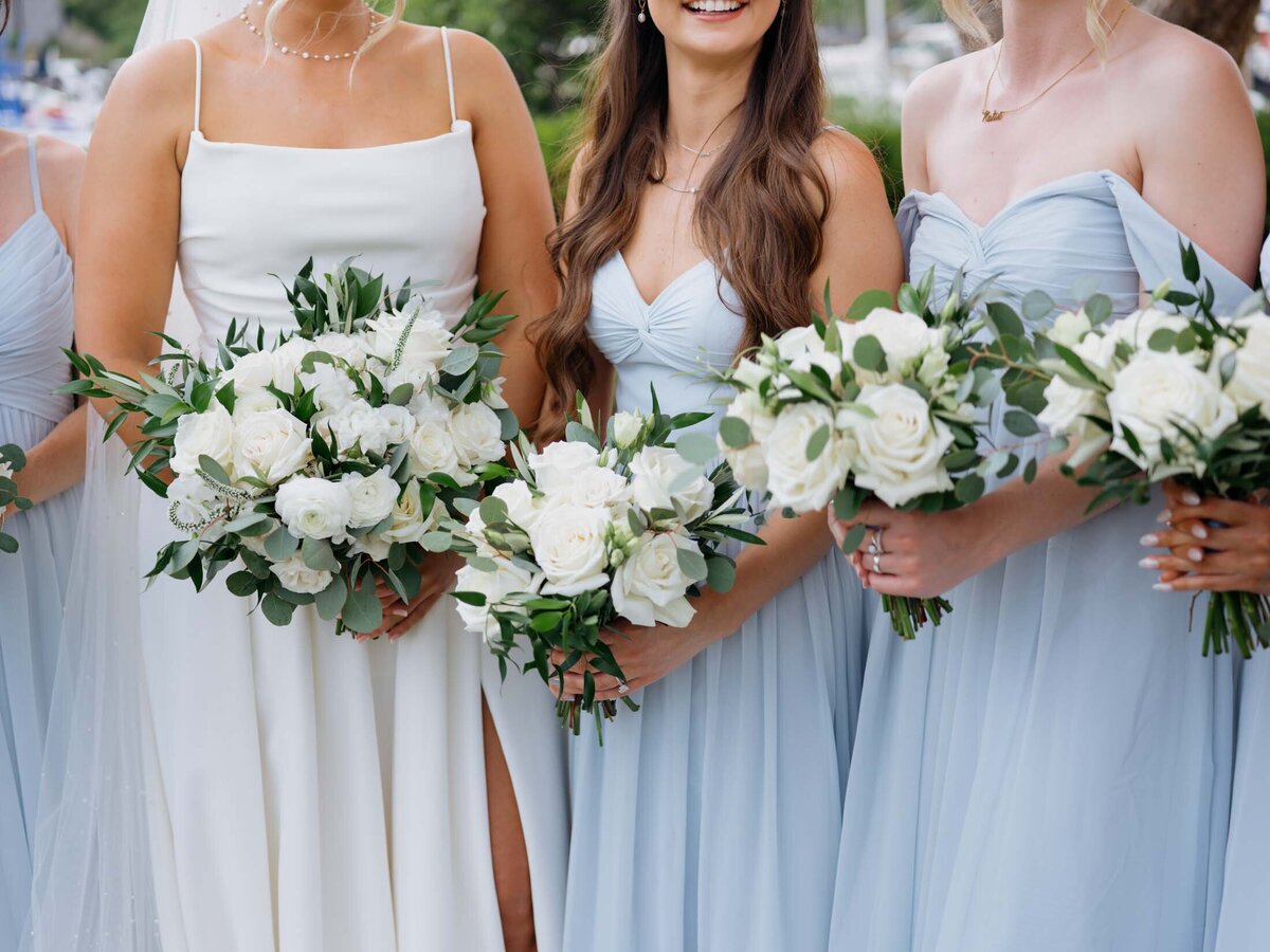 Bride with bridesmaids in light blue dresses at Cleveland Yachting Club