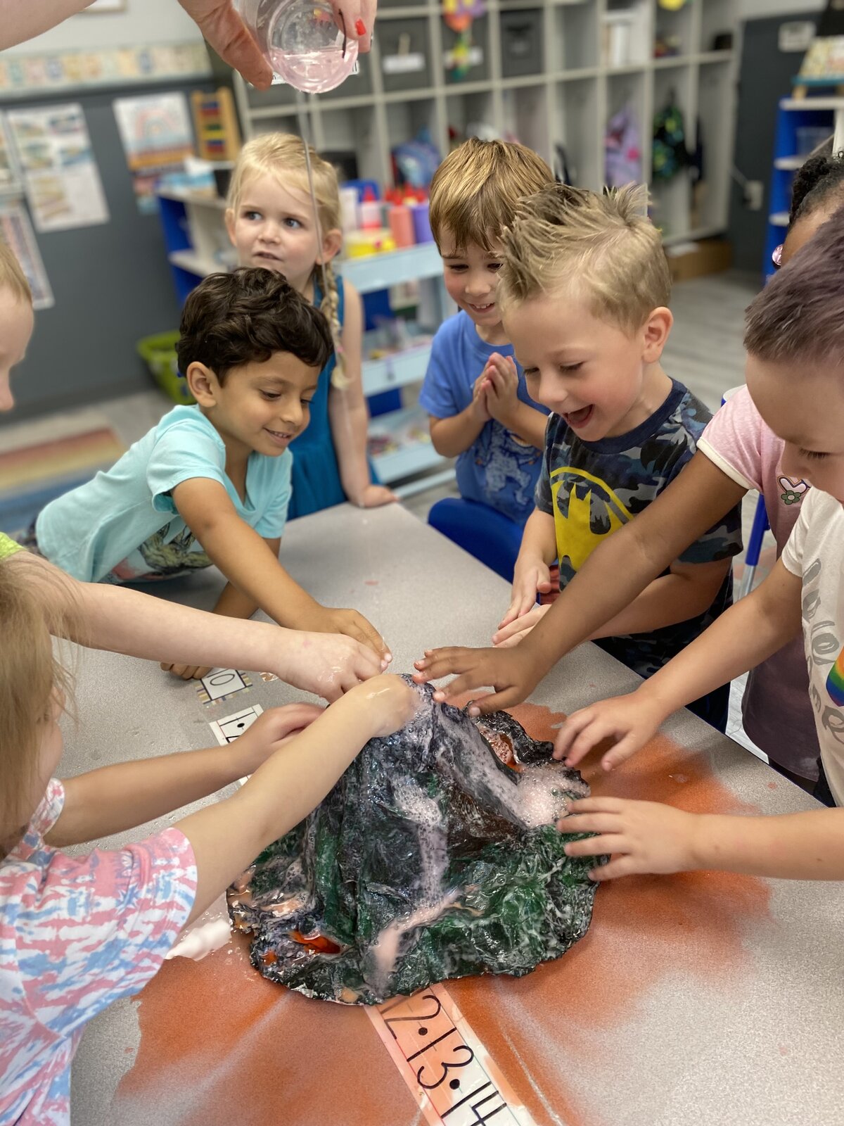 Engage in educational fun with kids playing a volcano game.