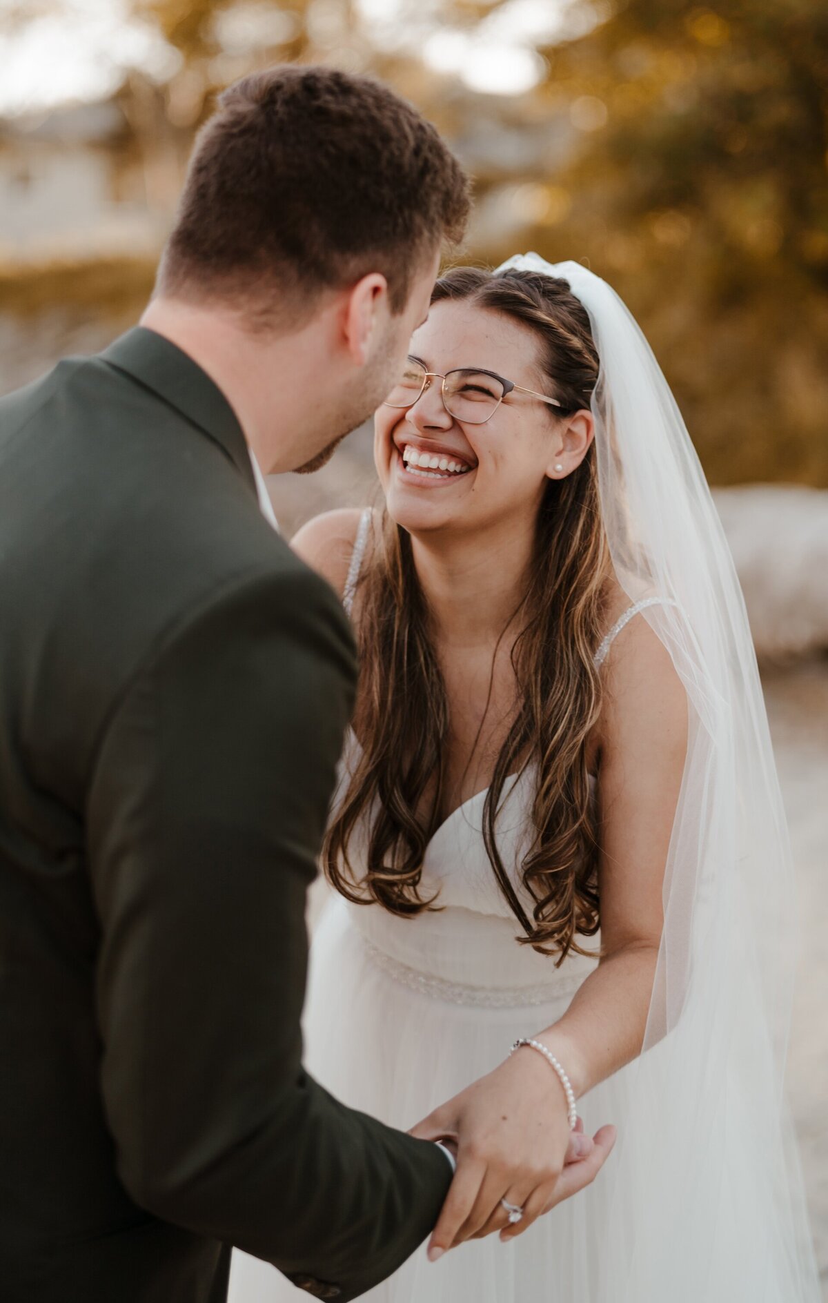 a bride and groom holding hands and smiling