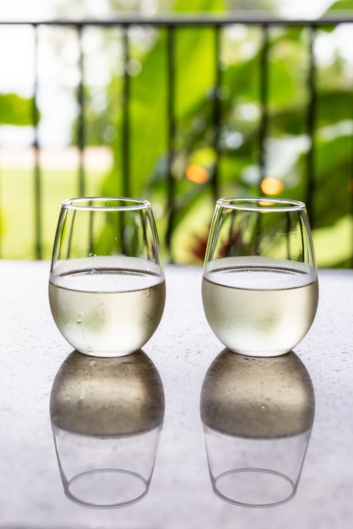 Outrigger Kona's Voyager 47 Club welcome pineapple white wine served on a club table with a reflection.