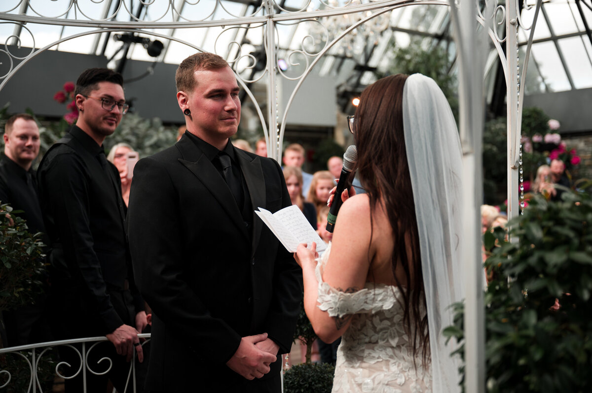Bride reading her vows to her groom on their wedding day