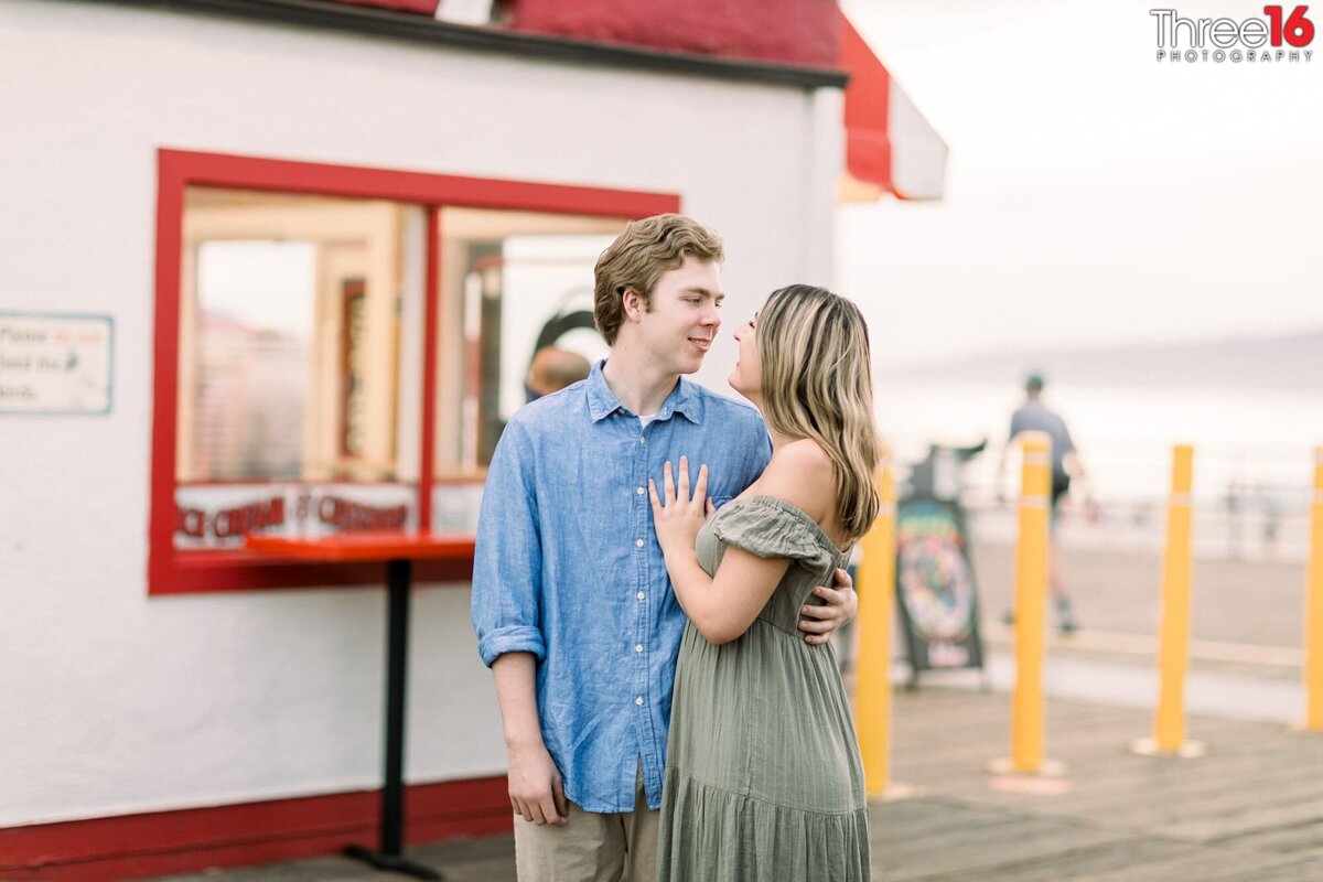 Engaged couple gaze into each other's eyes during engagement photo session