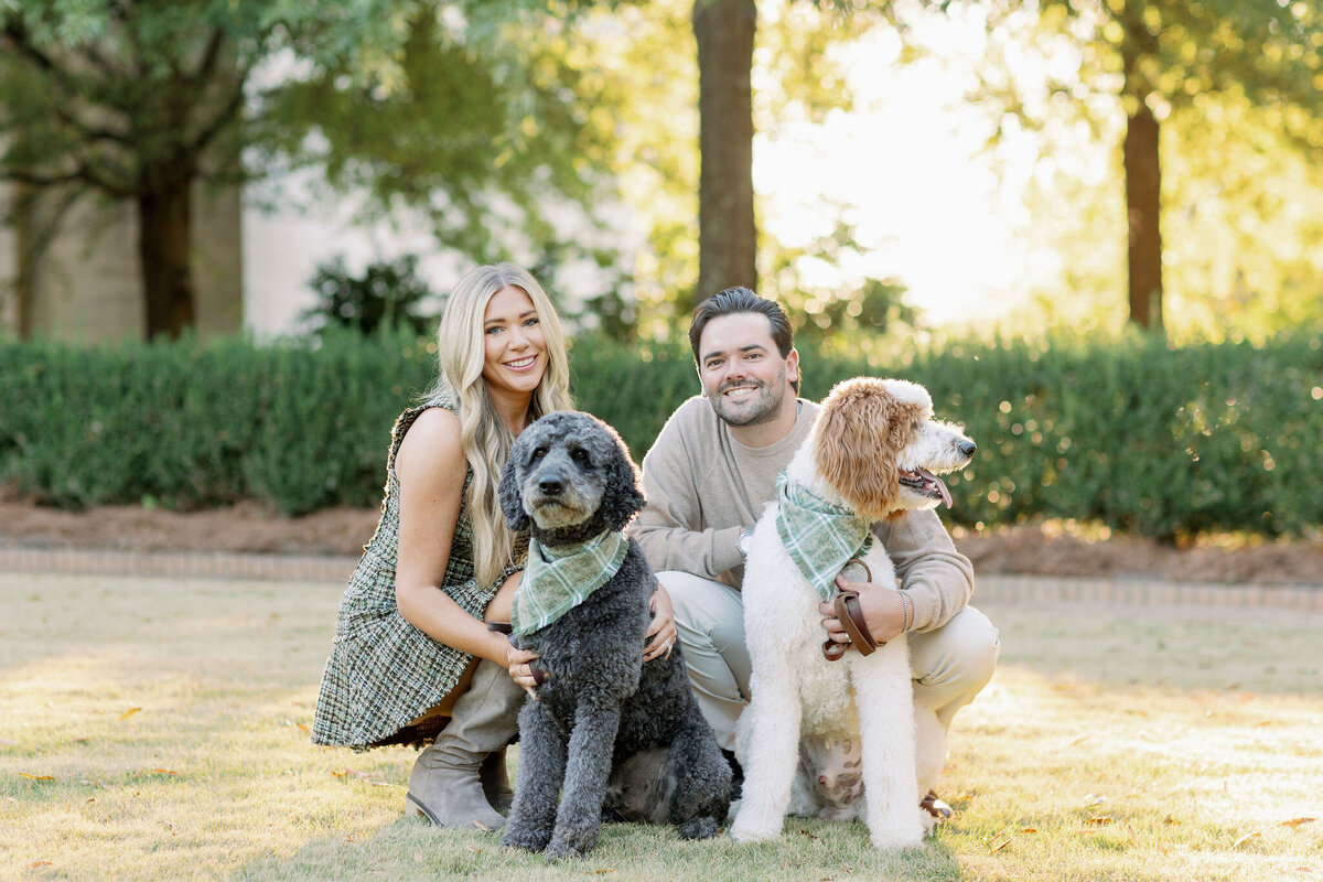 Couple and two dogs posing in the woods