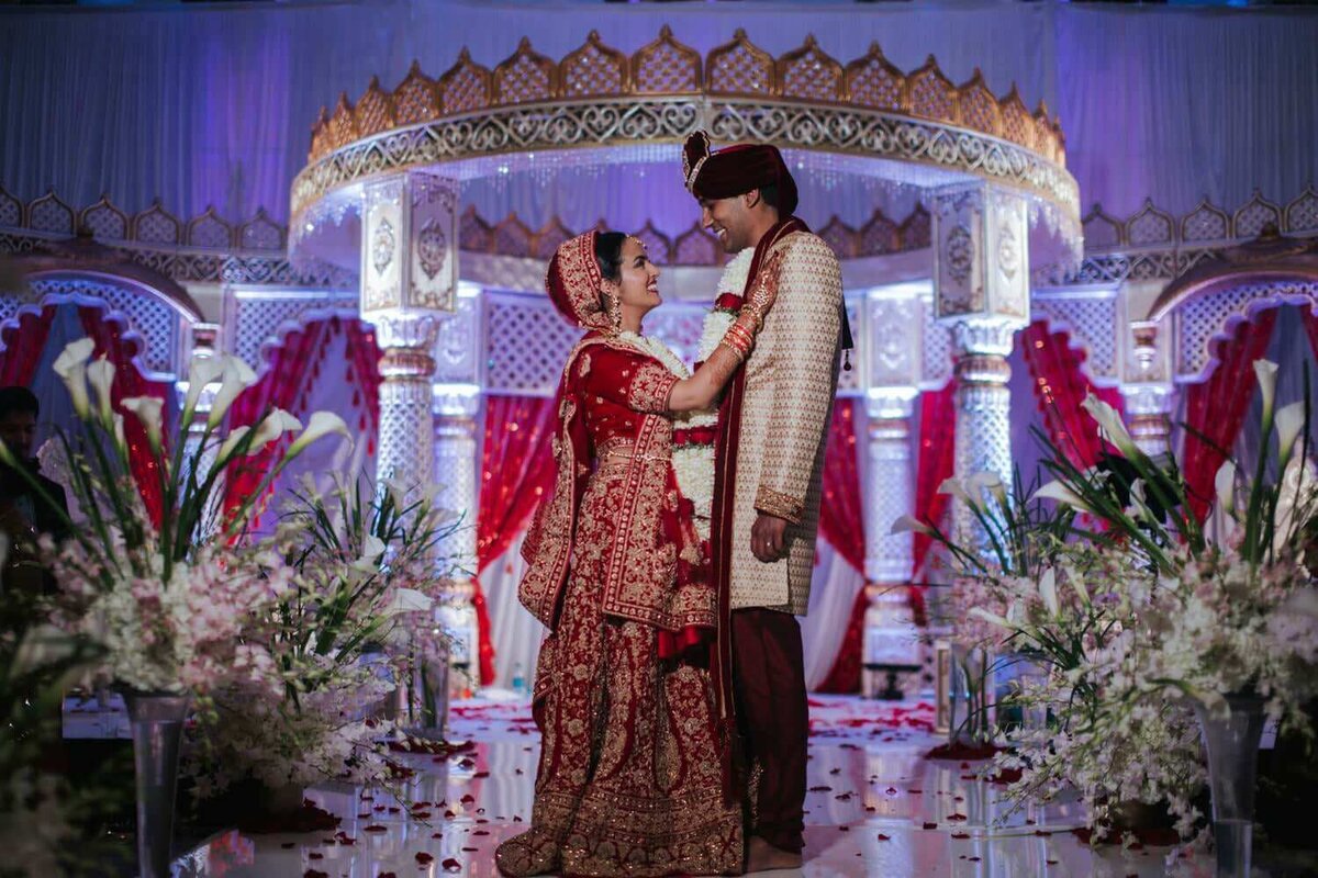 South Asian bride and groom look up at each other excited for the days festivities in King of Prussia