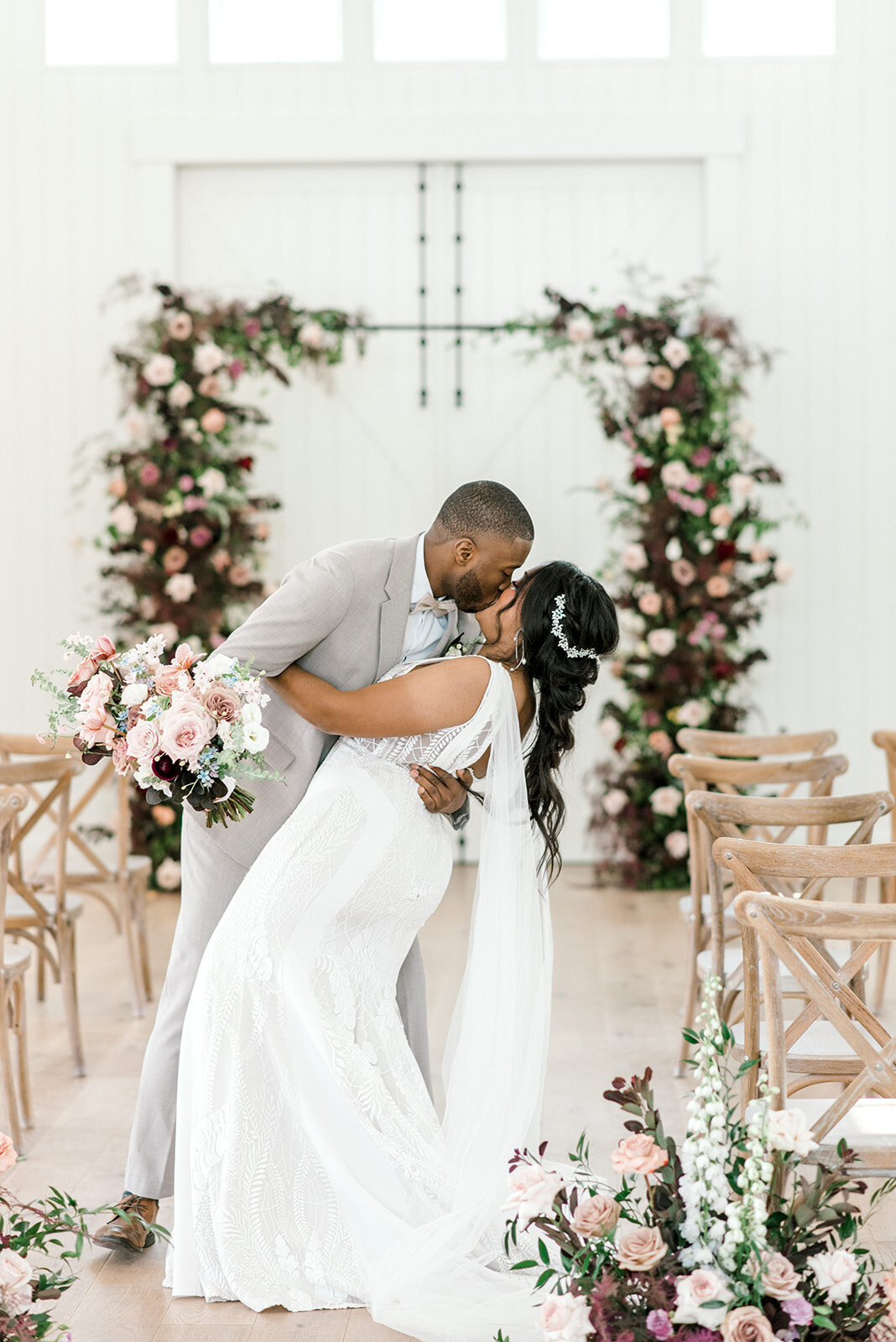 Bride and groom kiss at the altar
