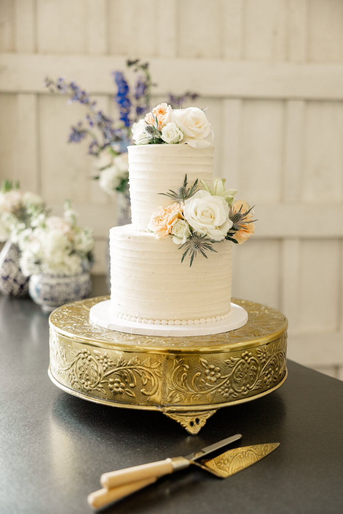 Simple & elegant wedding cake on golden cake platter. 