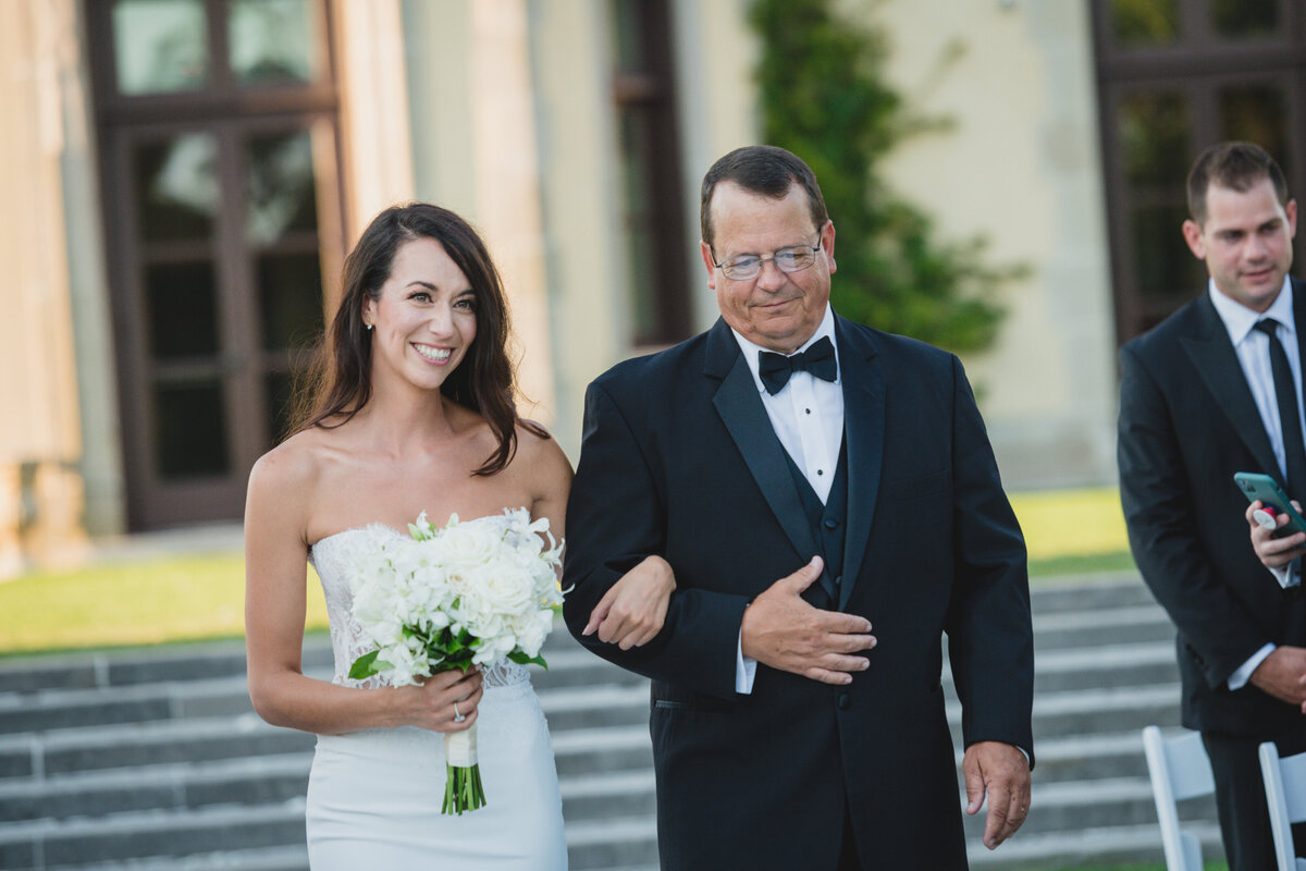 bride and father walking down the aisle at Oheka Castle