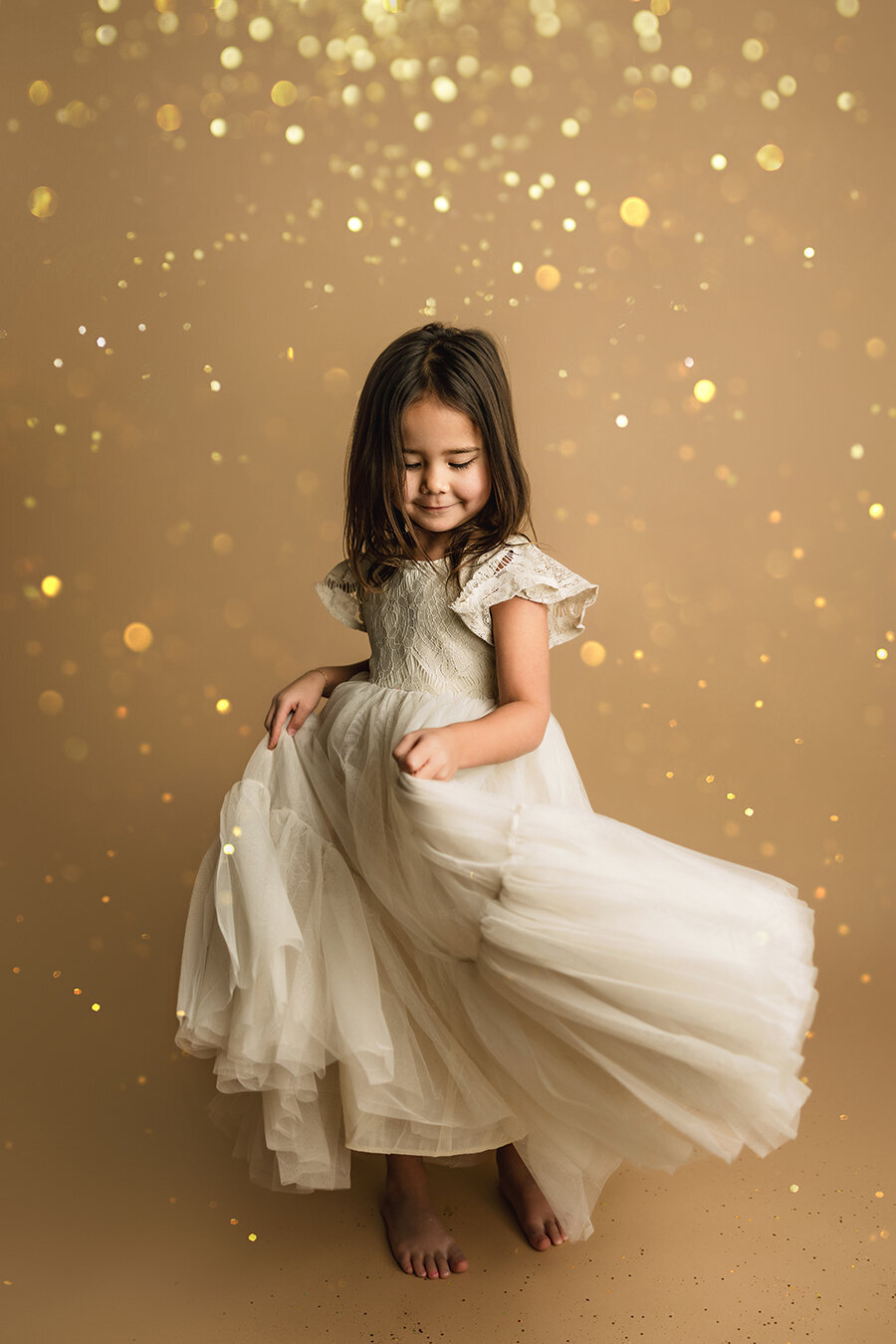 Beautiful girl twirling her dress in glitter in Fort Collins area photography studio