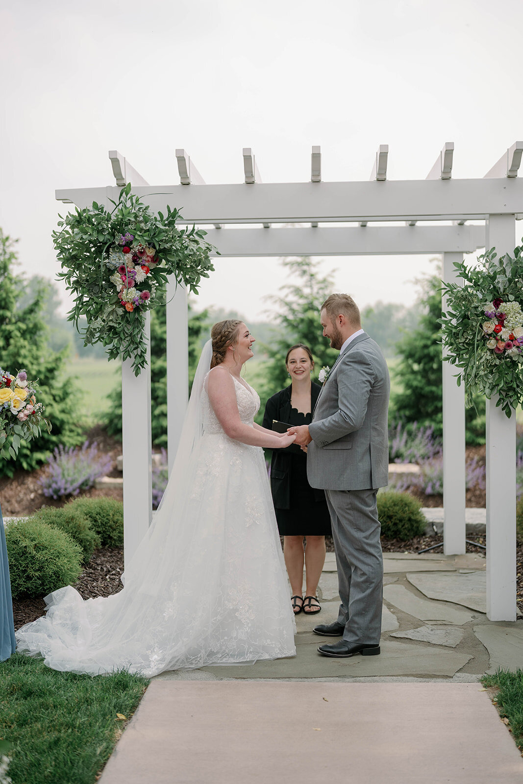 Bride and groom standing together during their outdoor ceremony at The Blue Heron Barn wedding venue in Kalamazoo, MI.