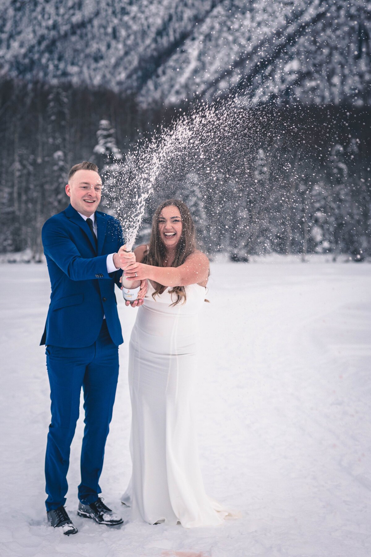 A wedding couple pops some bubbly on their wedding day