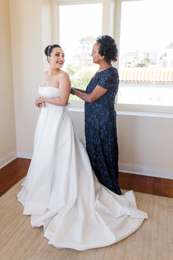 mother-helping-bride-get-dressed