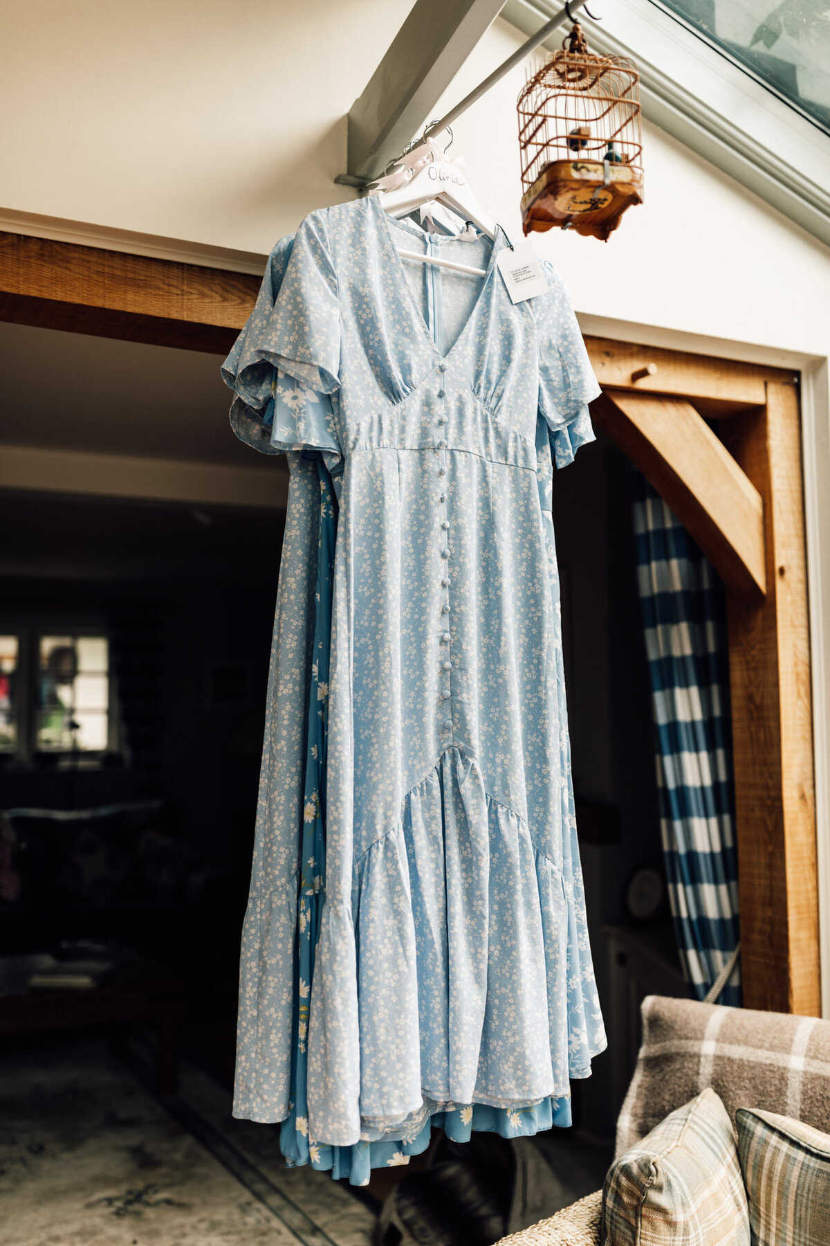 Photo of light blue dress hanging up before being put on