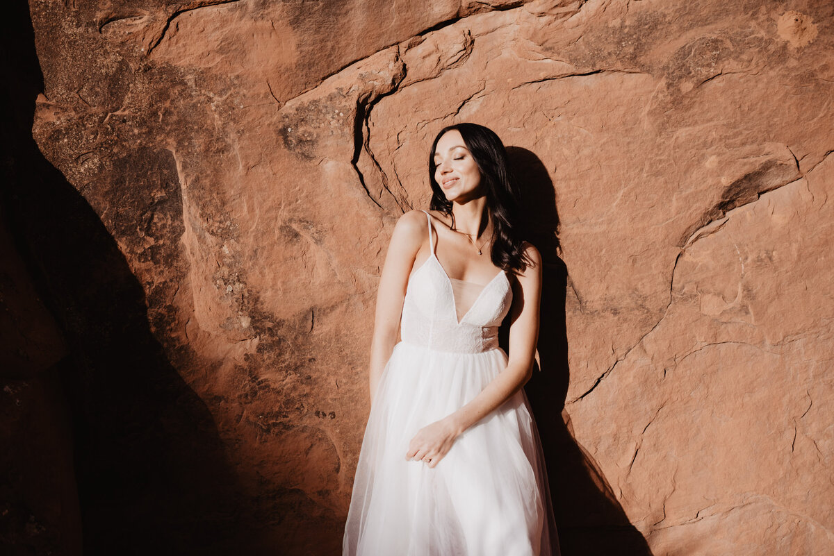 Utah elopement photographer captures bride touching wedding dress