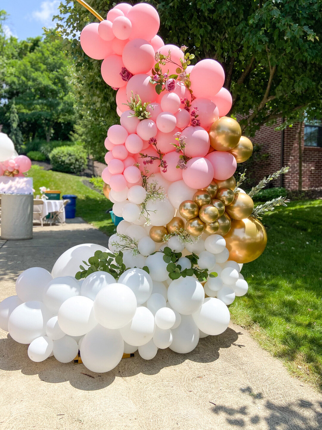 grand entrance balloon arch outdoors pink white and gold