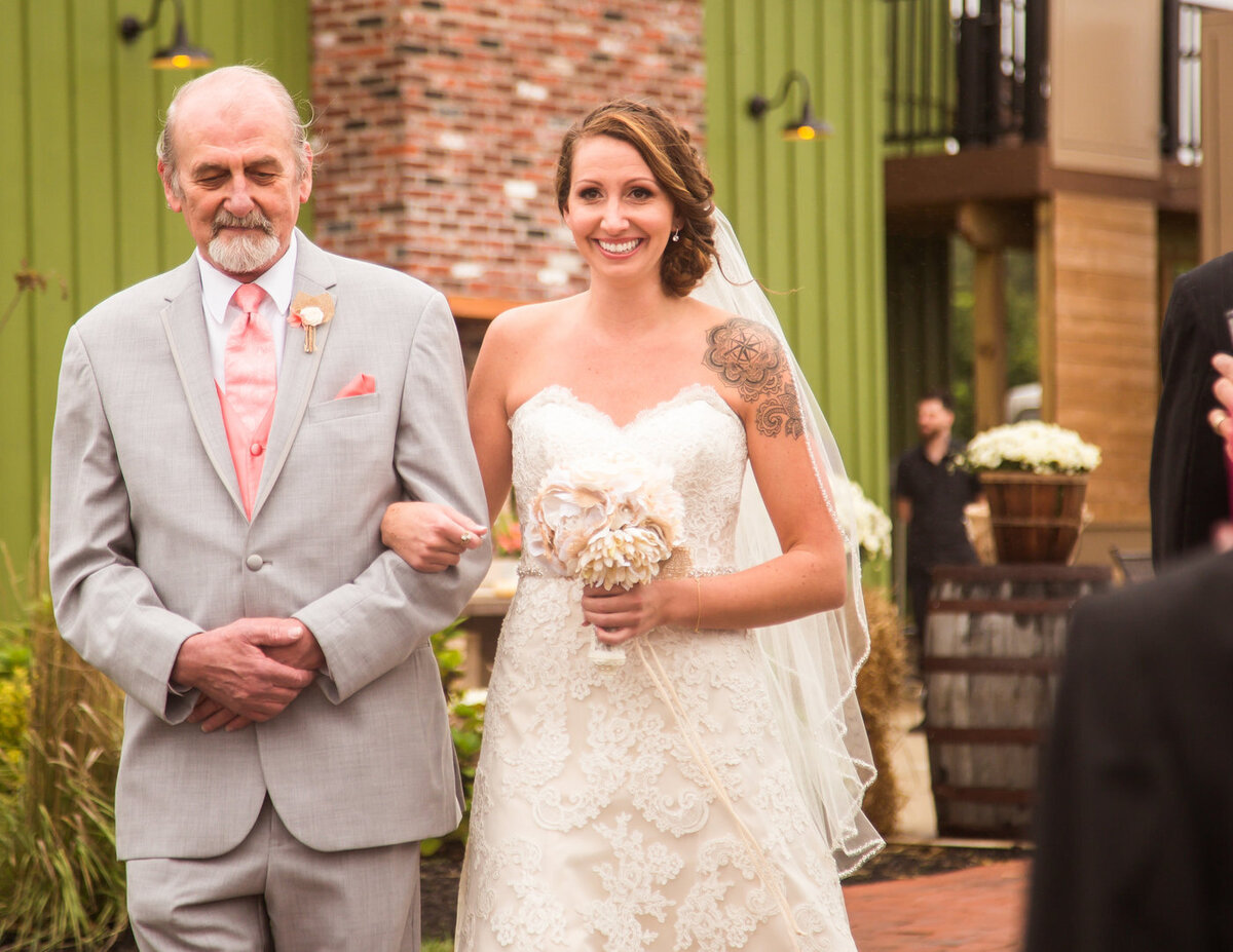 Smiling bride walking down the aisle in Florida wedding by Central Florida Photographer