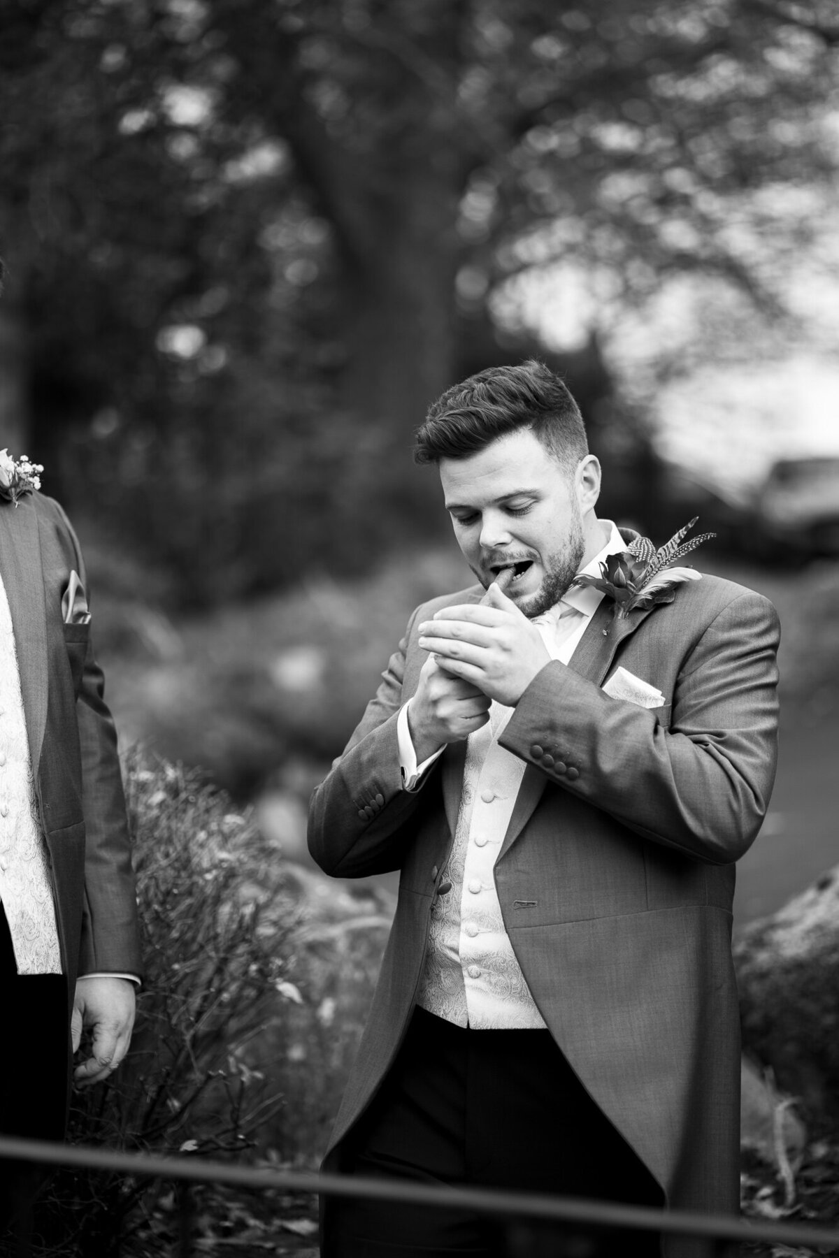 Groom lighting a cigar at Merewood Country House Hotel