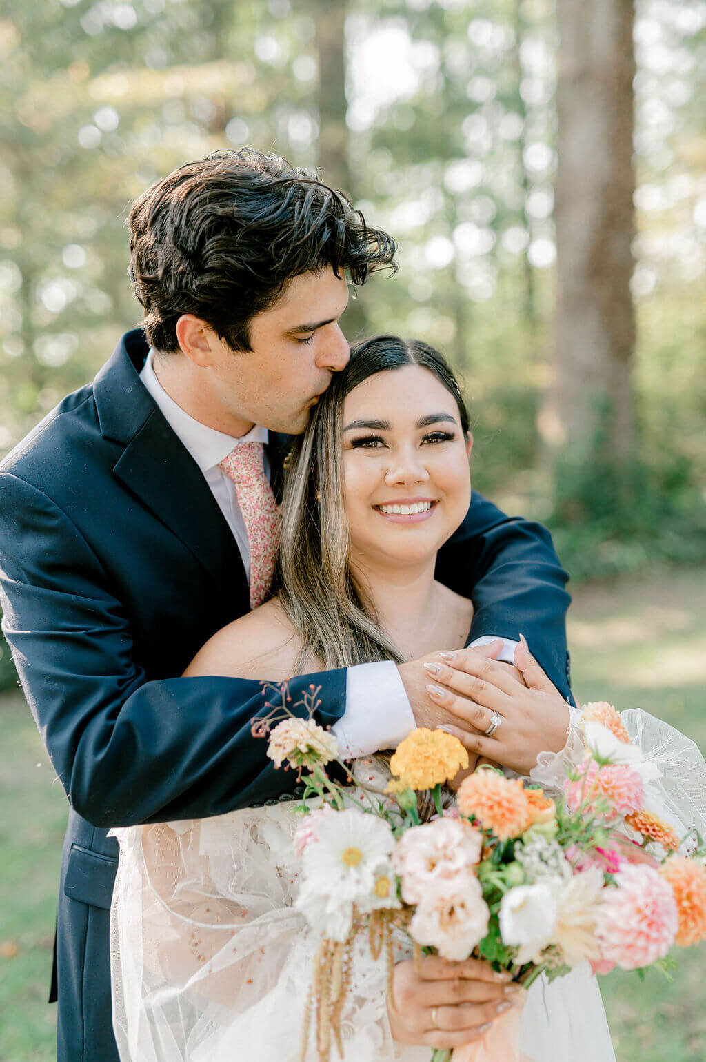 groom wrapping his arms around his new wife on their wedding day 